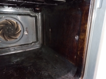 Dirty brown oven interior before being cleaned