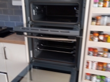 Double oven with doors open after being cleaned