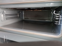 Small oven grill without shelves after being cleaned