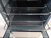 Clean grey oven interior with shelves and open door