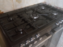 Black double oven hob with silver fixings after being cleaned