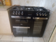 Black double oven with silver fixings after being cleaned