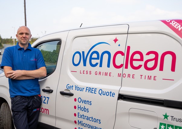Ovenclean franchisee Tony Lyth stood next to Ovenclean van in uniform