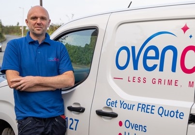 Ovenclean franchisee Tony Lyth stood next to Ovenclean van in uniform
